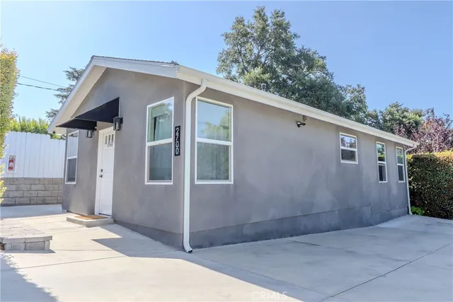 a view of a house with a yard and plant
