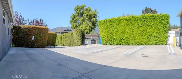 a view of a road with a house in the background