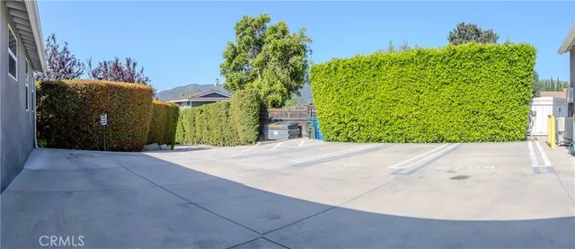 a view of a road with a house in the background