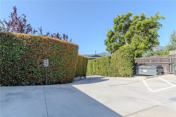 a front view of a house with a yard and potted plants
