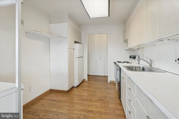 a kitchen with a sink and refrigerator