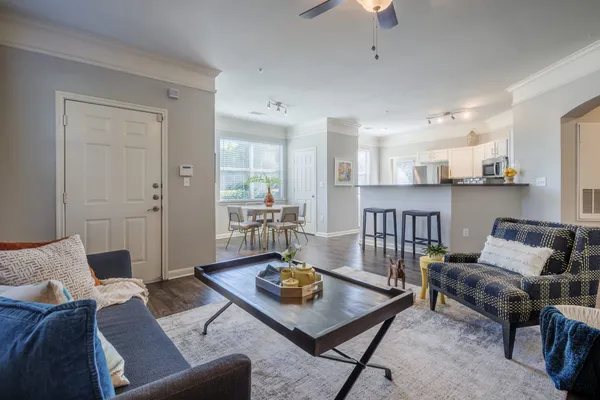 a living room with furniture and wooden floor