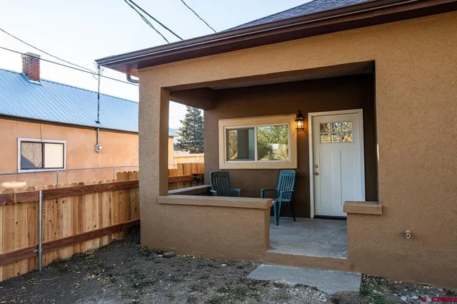 a workspace room with furniture and a window