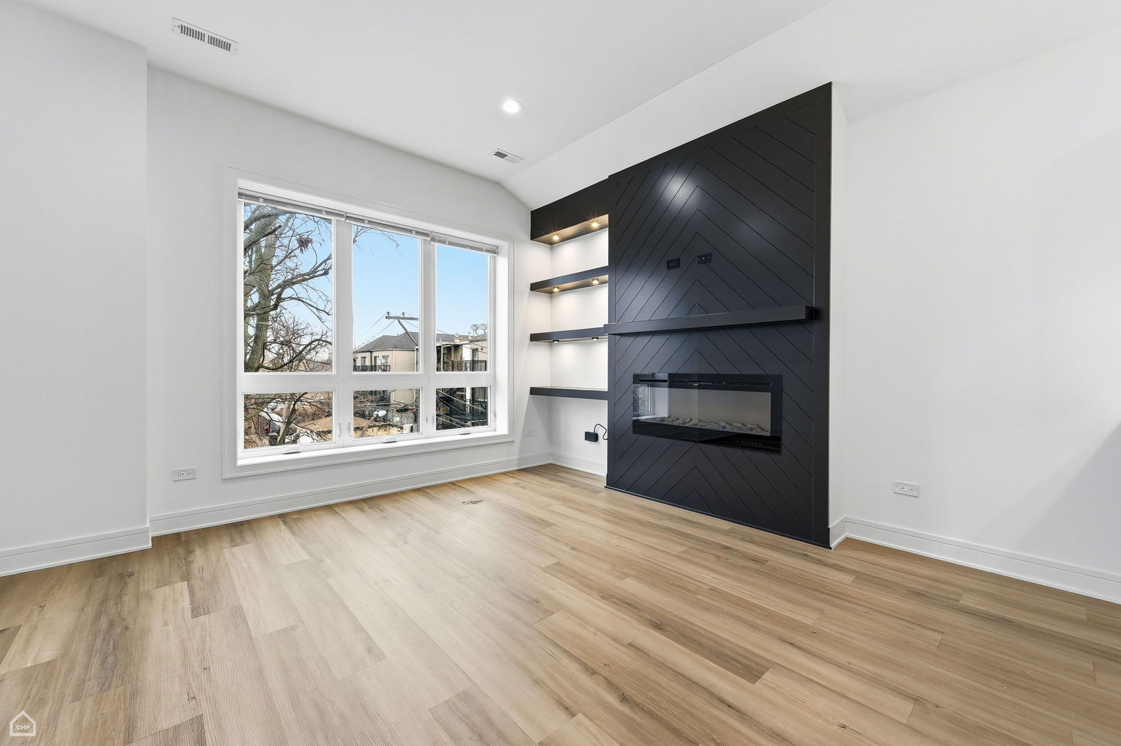861 East 63rd Place, Unit 3 Chicago, IL 60637 - Photo 2 of 20 a view of an empty room with a window and wooden floor