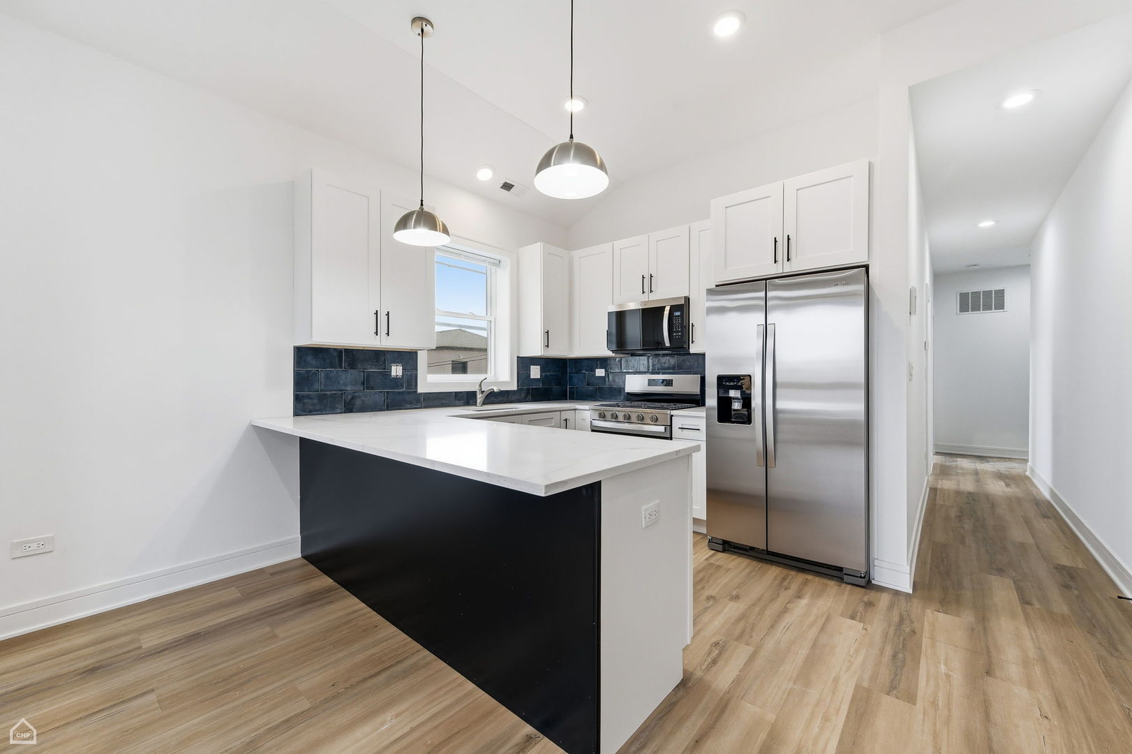 861 East 63rd Place, Unit 3 Chicago, IL 60637 - Photo 7 of 20 a kitchen with kitchen island a counter space a sink appliances and cabinets