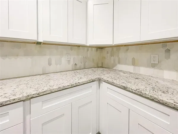 a view of a kitchen with a sink a window and wooden floor