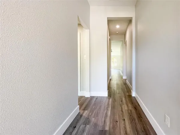 a view of a room with wooden floor