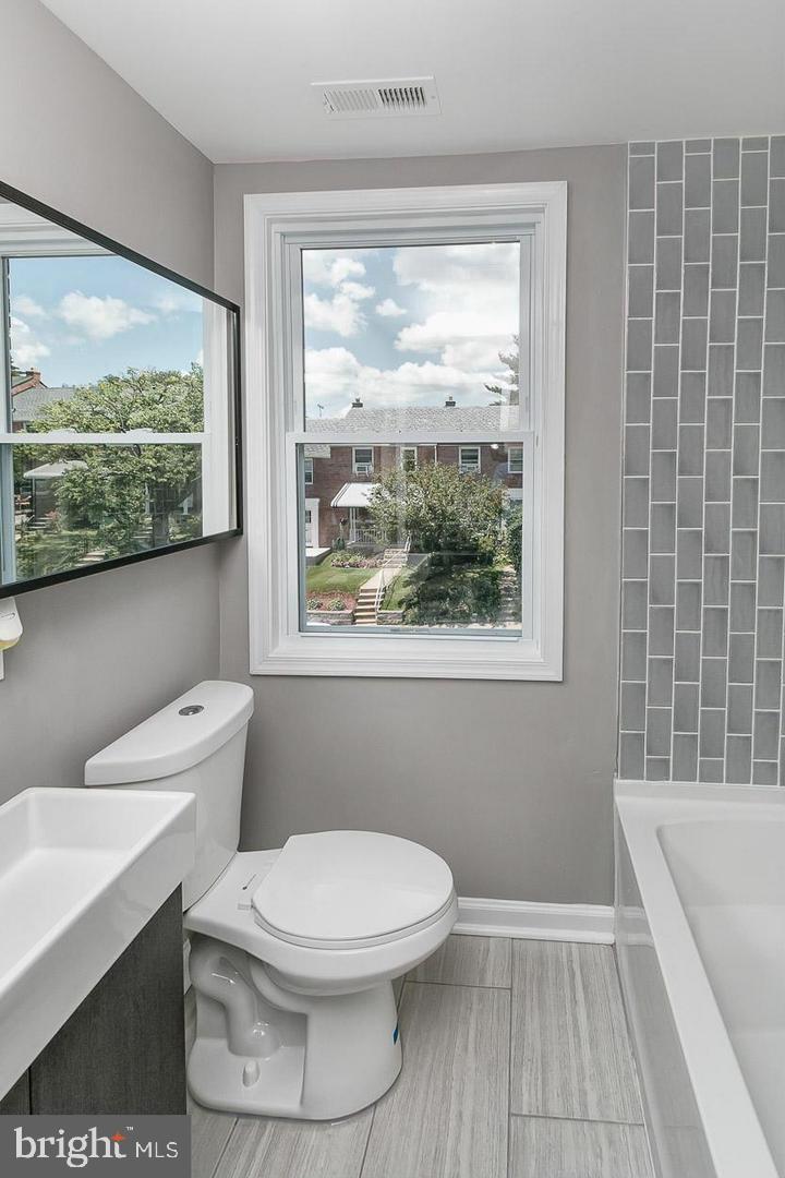 3815 Yolando Road Baltimore, MD 21218 - Photo 11 of 20 a bathroom with a toilet a sink and a bathtub