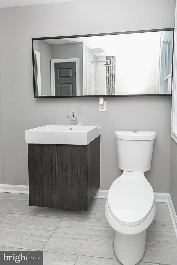 3815 Yolando Road Baltimore, MD 21218 - Photo 12 of 20 a bathroom with a toilet sink and mirror