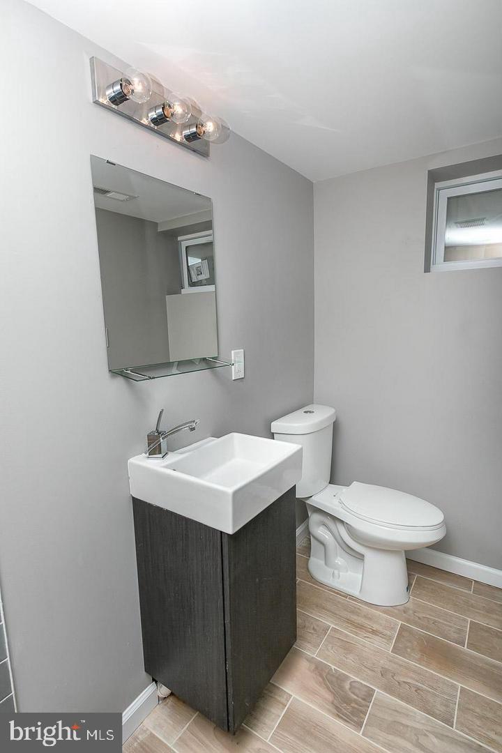 3815 Yolando Road Baltimore, MD 21218 - Photo 19 of 20 a bathroom with a toilet sink and mirror