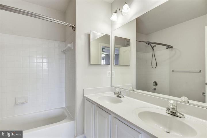576 Orchard Ridge Drive, Unit 100 Gaithersburg, MD 20878 - Photo 19 of 44 a bathroom with a bathtub shower sink vanity and mirror
