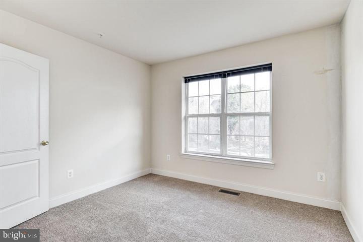 576 Orchard Ridge Drive, Unit 100 Gaithersburg, MD 20878 - Photo 25 of 44 an empty room with a window