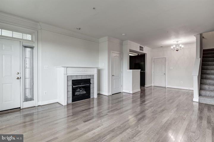576 Orchard Ridge Drive, Unit 100 Gaithersburg, MD 20878 - Photo 4 of 44 wooden floor fireplace and natural light in room