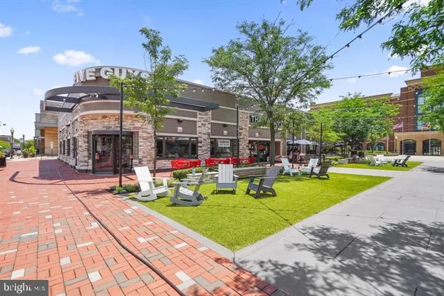 a view of a swimming pool with sitting area and furniture
