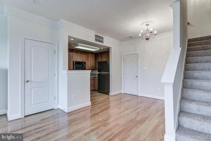 576 Orchard Ridge Drive, Unit 100 Gaithersburg, MD 20878 - Photo 8 of 44 a view of a kitchen cabinets and wooden floor