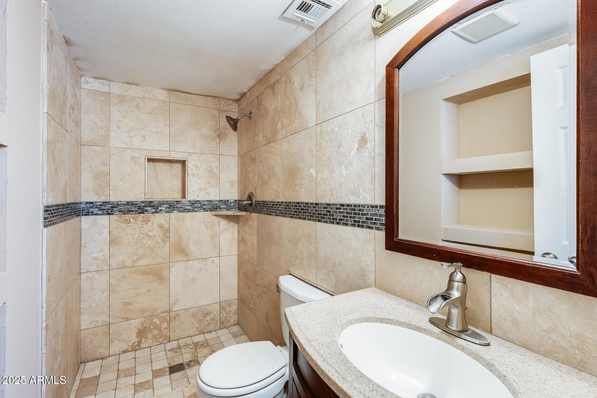 17633 North 15th Avenue Phoenix, AZ 85023 - Photo 13 of 32 a bathroom with a sink mirror vanity and toilet