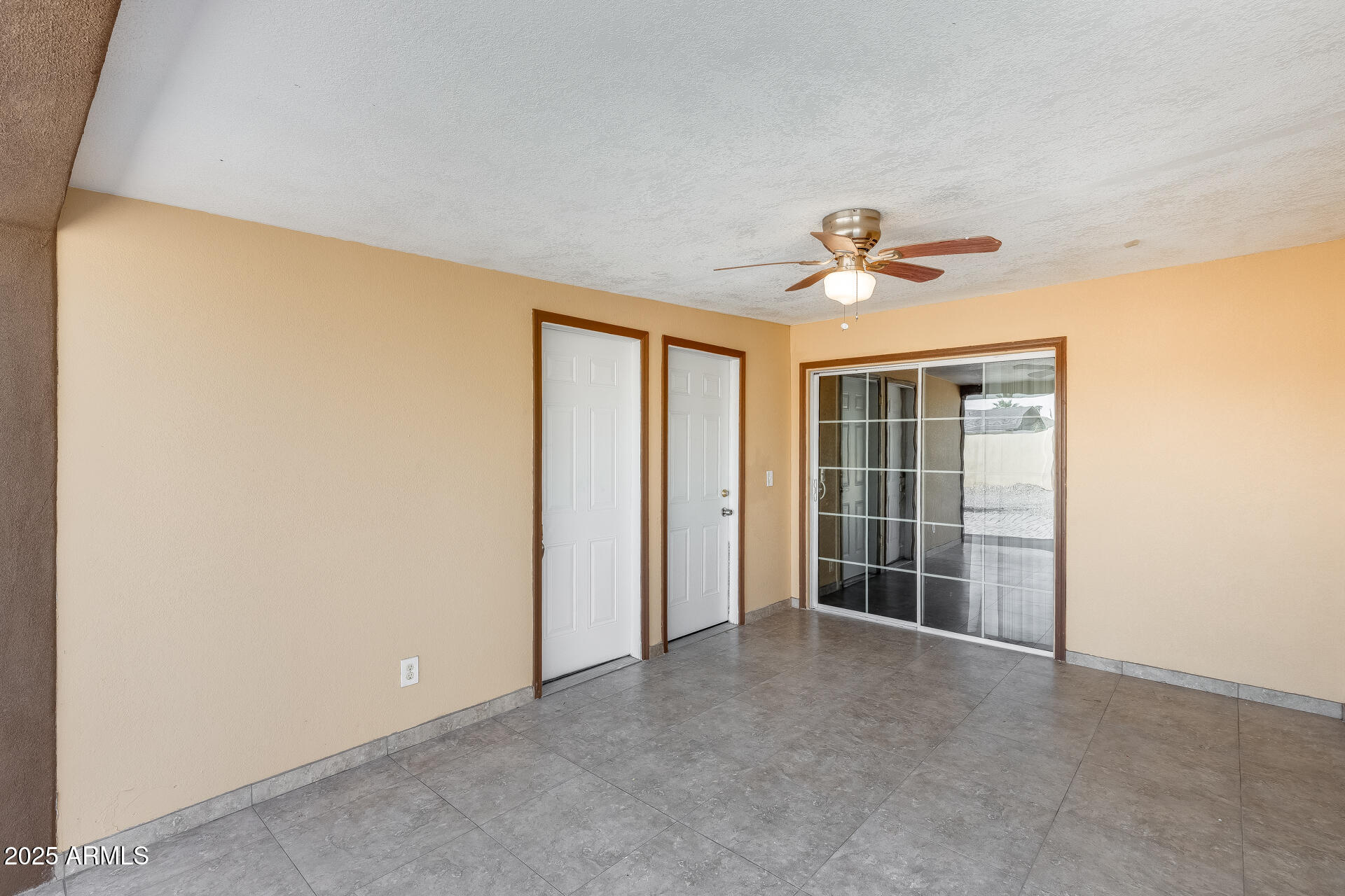 17633 North 15th Avenue Phoenix, AZ 85023 - Photo 21 of 32 an empty room with windows and ceiling fan