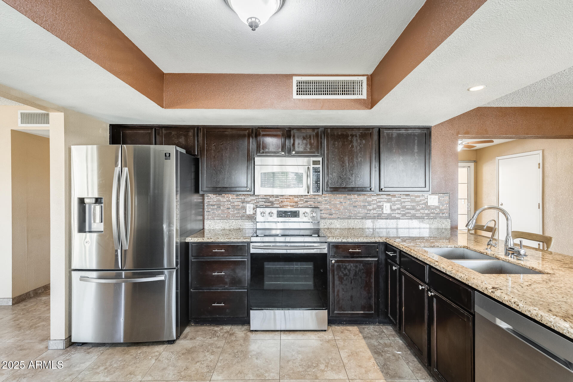 17633 North 15th Avenue Phoenix, AZ 85023 - Photo 2 of 32 a kitchen with stainless steel appliances granite countertop a sink stove and refrigerator