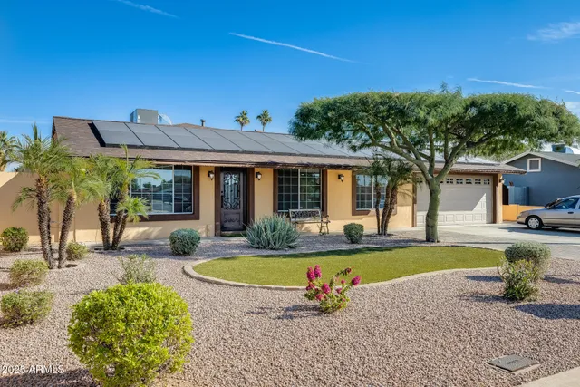 a view of a house with backyard sitting area and swimming pool