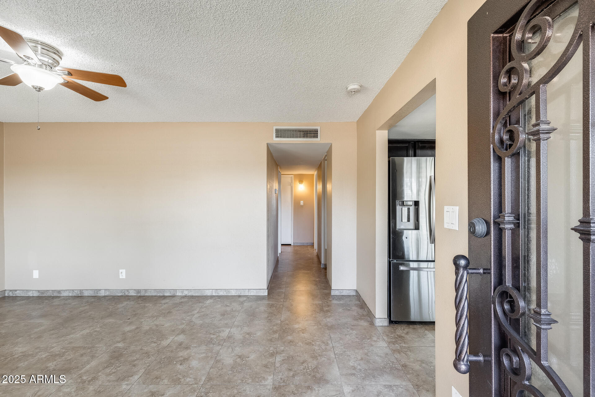 17633 North 15th Avenue Phoenix, AZ 85023 - Photo 5 of 32 a view of a hallway with a refrigerator
