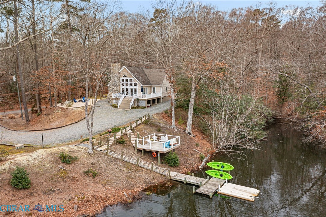 4775 Stormont Road Hartfield, VA 23071 - Photo 4 of 45 View of subject property featuring a nearby body of water and a tree filled landscape