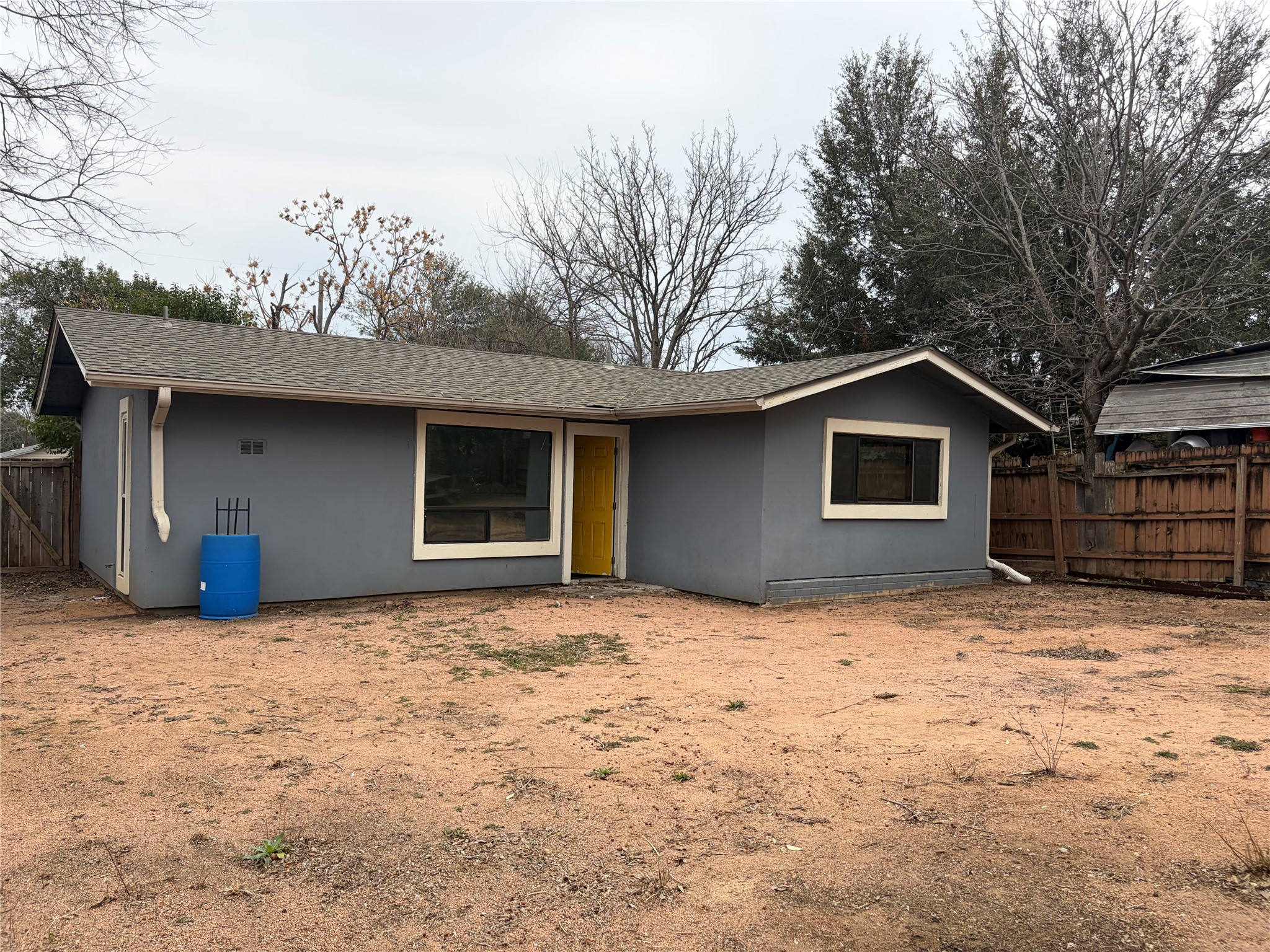 7404 Bethune Avenue Austin, TX 78752 - Photo 4 of 16 Rear view of property with a shingled roof and stucco siding