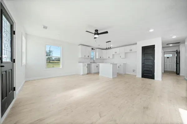 a view of a kitchen with a sink and a refrigerator