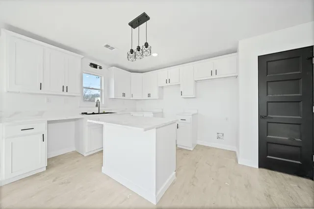 a kitchen with cabinets and window