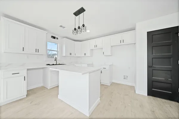 a kitchen with cabinets and window