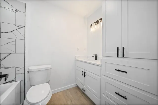 a bathroom with a toilet sink and mirror