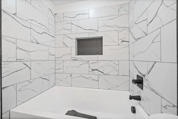 a bathroom with a bathtub and a shower