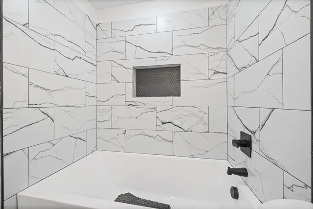 a bathroom with a bathtub and a shower