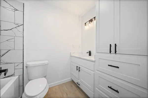 a bathroom with a toilet sink and mirror