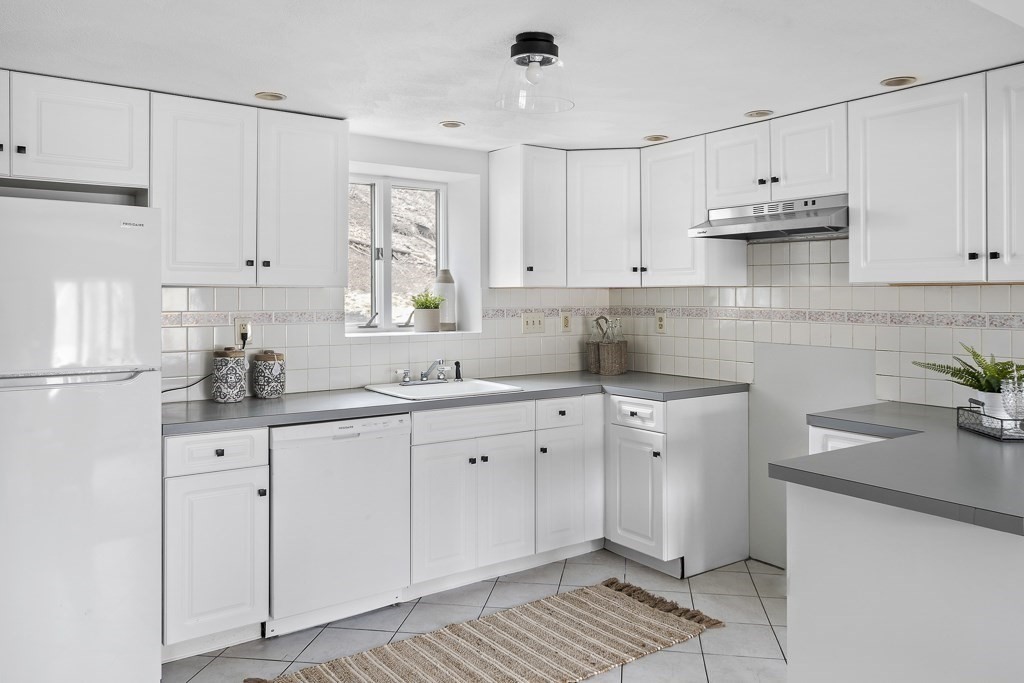 45 Brookbridge Road Stoneham, MA 02180 - Photo 21 of 34 a kitchen with granite countertop white cabinets white appliances and sink