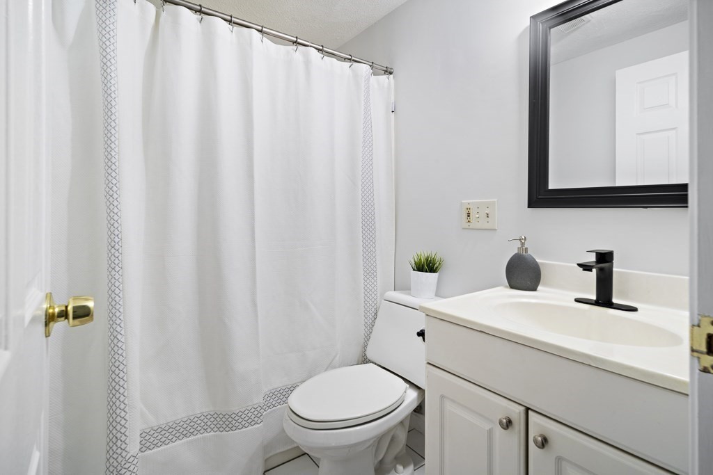 45 Brookbridge Road Stoneham, MA 02180 - Photo 25 of 34 a bathroom with a sink a toilet and a mirror