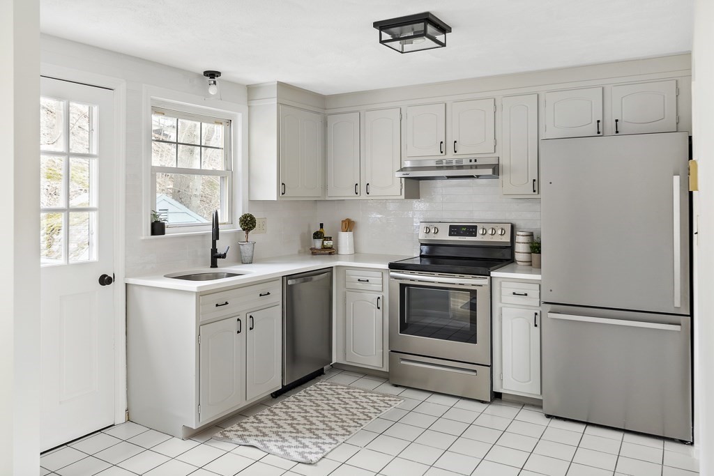 45 Brookbridge Road Stoneham, MA 02180 - Photo 4 of 34 a kitchen with cabinets stainless steel appliances and a window