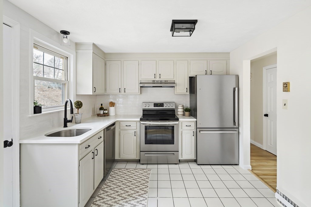 45 Brookbridge Road Stoneham, MA 02180 - Photo 5 of 34 a kitchen with a refrigerator sink and cabinets