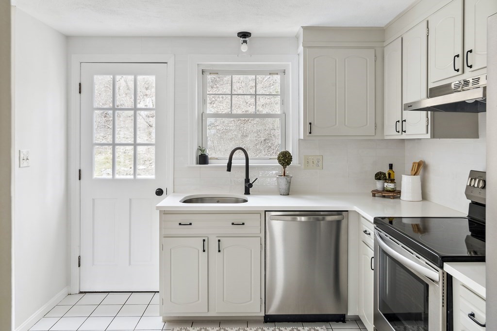 45 Brookbridge Road Stoneham, MA 02180 - Photo 6 of 34 a kitchen with stainless steel appliances granite countertop a sink stove and cabinets