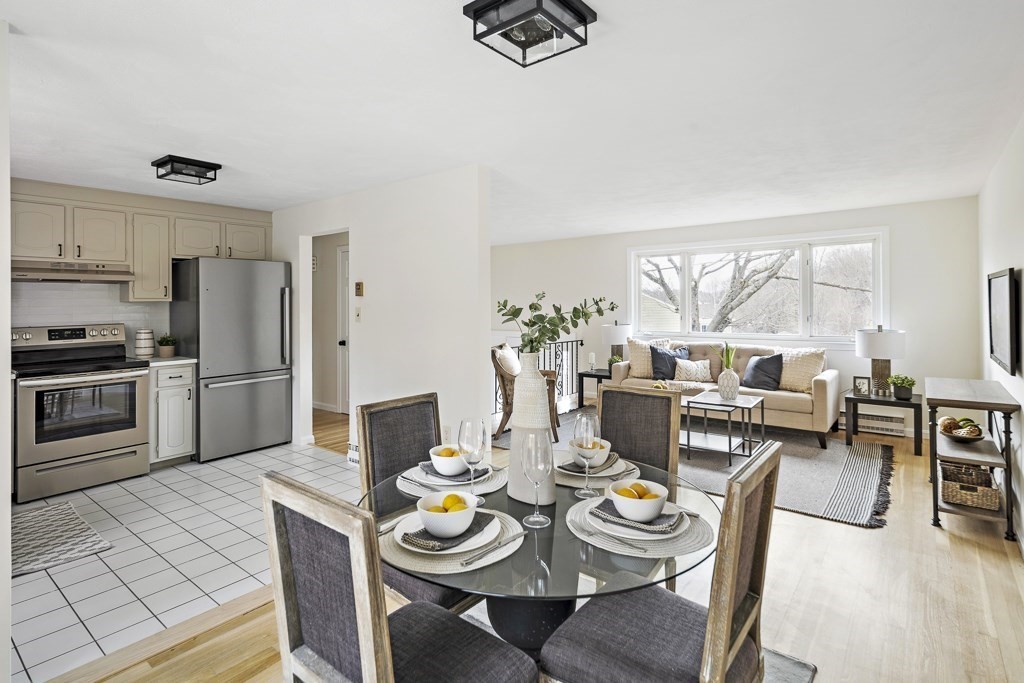 45 Brookbridge Road Stoneham, MA 02180 - Photo 9 of 34 a kitchen with stainless steel appliances granite countertop a stove a dining table and chairs