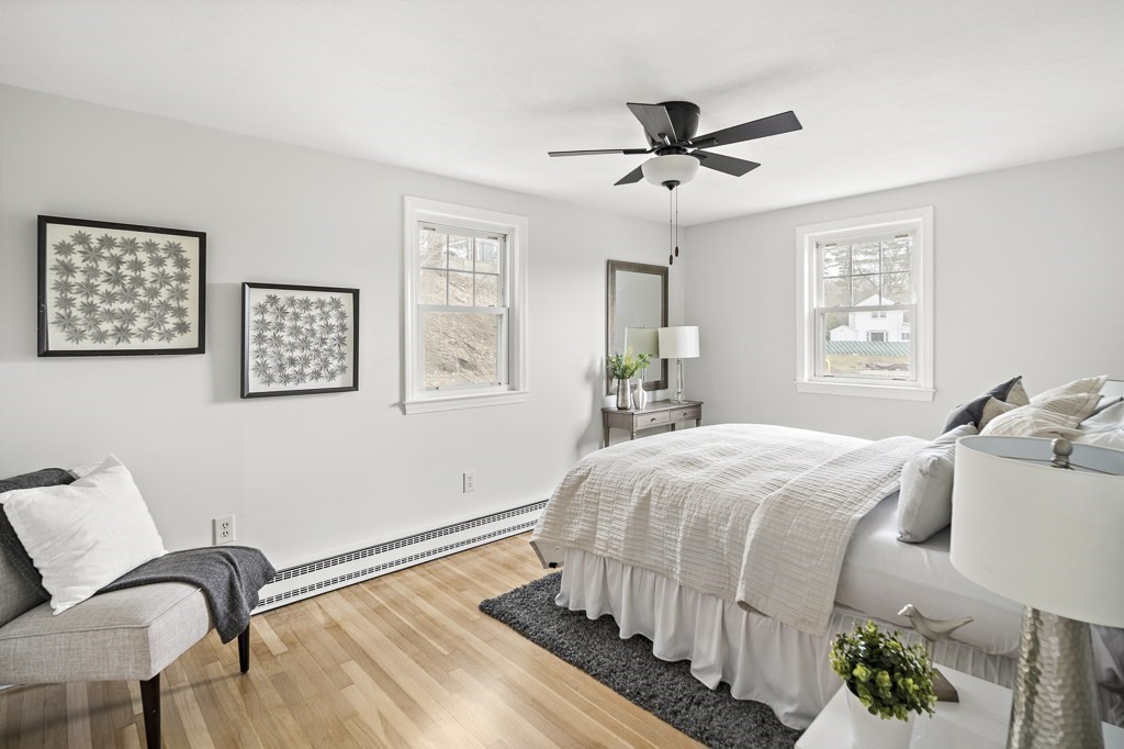 45 Brookbridge Road Stoneham, MA 02180 - Photo 10 of 34 a bedroom with a bed and wooden floor