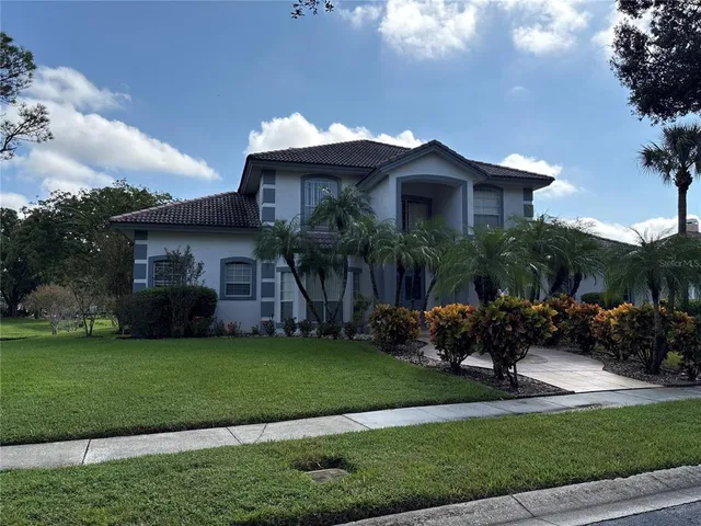 a front view of a house with a garden and plants