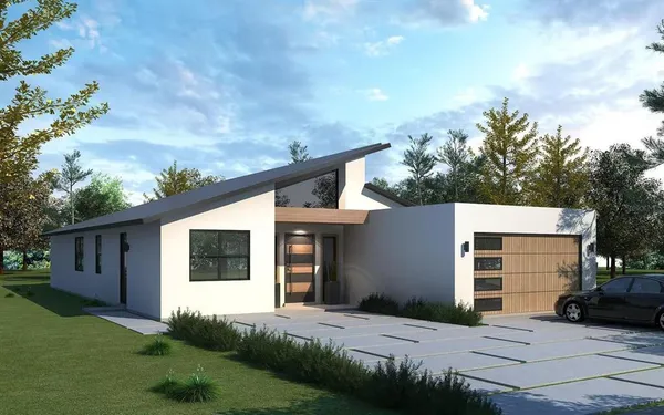 a front view of a house with a garden