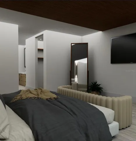 a bedroom with a bed and a flat screen tv