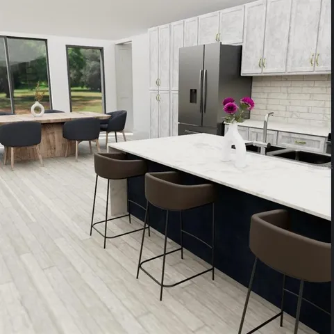 a kitchen with a table chairs and refrigerator