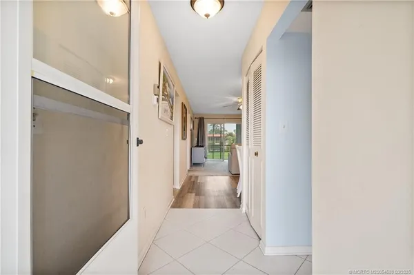 a view of a hallway with wooden floor and entryway