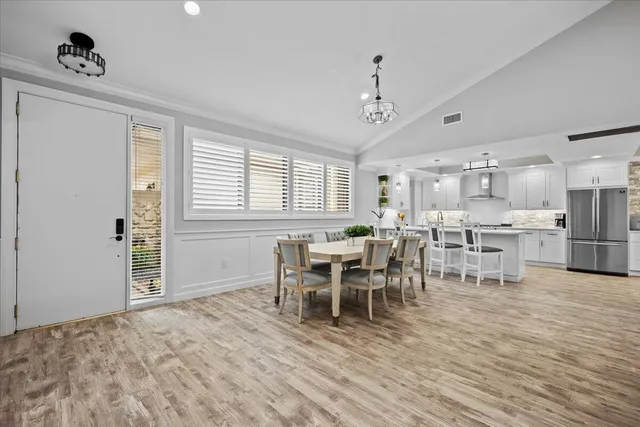 a view of a dining room with furniture and window
