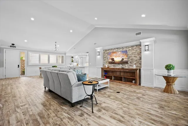 a living room with furniture and a wooden floor