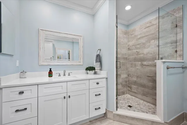 a bathroom with a shower a sink and a mirror