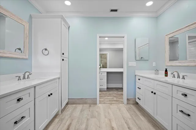 a kitchen with stainless steel appliances kitchen island a sink table and chairs