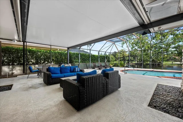 a swimming pool with outdoor seating and yard